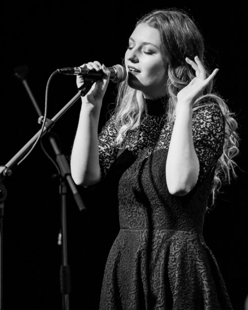 Black and white photo of singer Riley music singing at Freckfest HAC Irvine